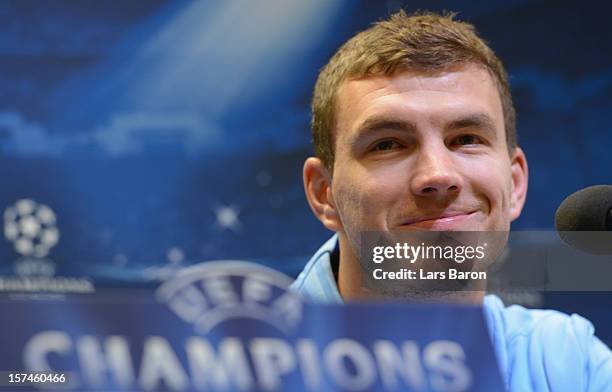 Edin Dzeko looks on during a Manchester City press conference ahead of their UEFA Champions League group stage match against Borussia Dortmund at...