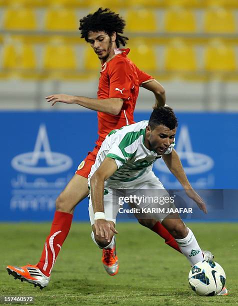 Bahrain's Hassan Jameel Yaseen vies for the ball against Iraq's Walid Salem during their international friendly football match in Doha on December 3,...