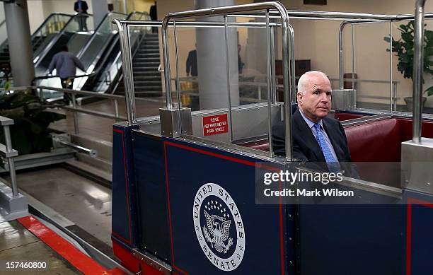 Sen. John McCain rides on the Senate subway after participating in a news conference with people who have disabilities on Capitol Hill, December 3,...