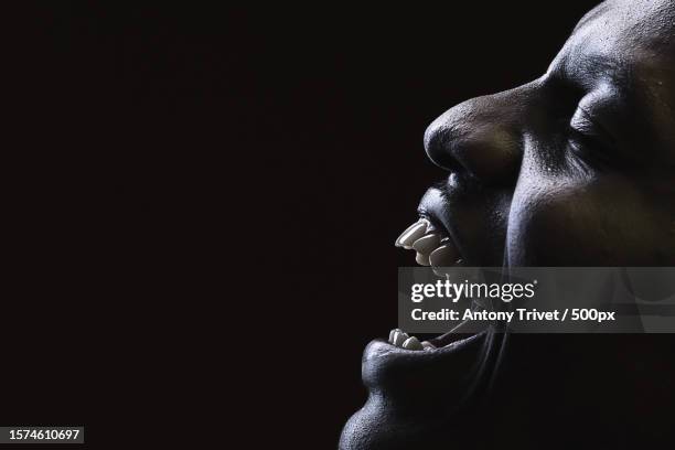 close-up of cheerful young man against black background,nairobi,kenya - dental fear fotografías e imágenes de stock