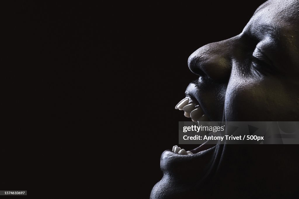 Close-up of cheerful young man against black background,Nairobi,Kenya