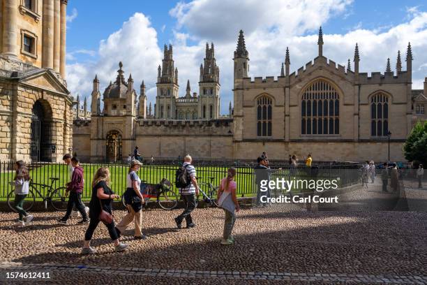 People walk past the Radcliffe Camera on August 3, 2023 in Oxford, England. Oxford's city council proposed a 20-year urban plan for "15-minute"...