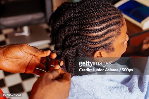 Young barber spends time working on clients hair,Salon work,Tema,Ghana