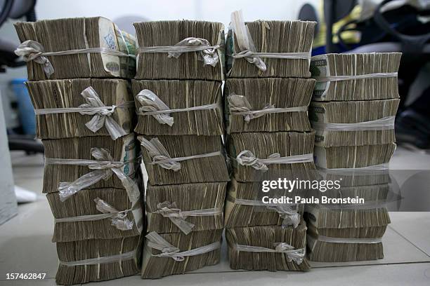 Burmese Kyat is seen tied up after being counted at a bank November 30, 2012 in downtown Yangon, Myanmar. Burmese kyat is now available at ATM...