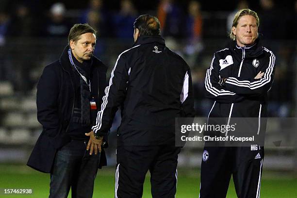 Manager Horst Heldt, head coach Huub Stevens and assistant coach Markus Gisdol talk during the training session of FC Schalke 04 at training ground...