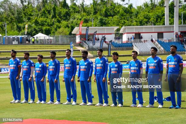 India players stand at attention for the national anthem during the first T20I match between West Indies and India at Brian Lara Cricket Academy in...
