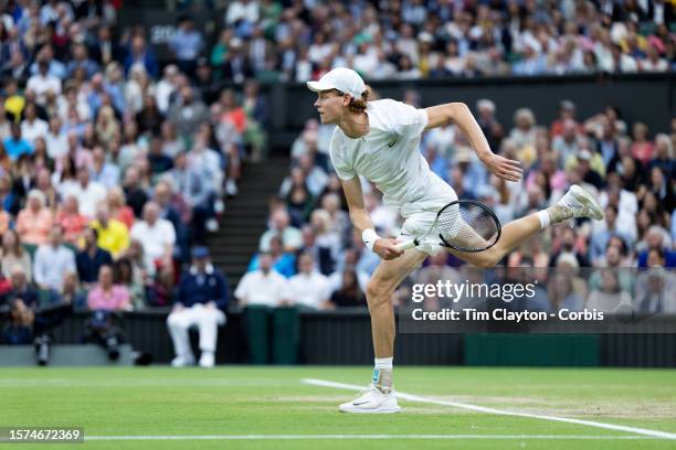 Jannik Sinner of Italy serving against Novak Djokovic of Serbia in the Gentlemens' Singles semi-final match on Centre Court during the Wimbledon Lawn...