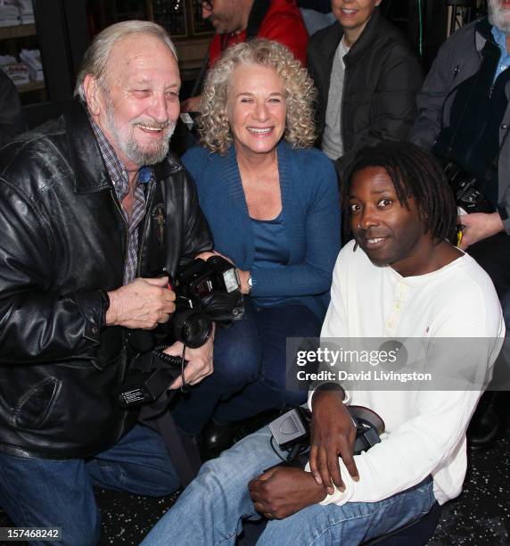 Recording artist Carole King poses with photographers at the ceremony honoring her with a Star on the Hollywood Walk of Fame on December 3, 2012 in...