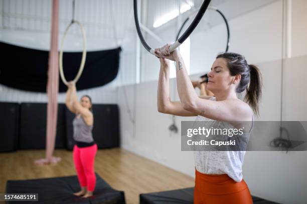 gymnasts holding a lyra hoop - lyra stock pictures, royalty-free photos & images