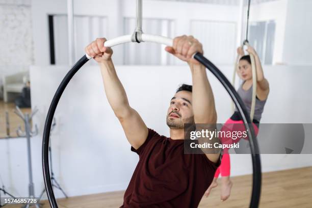 man holding a lyra hoop - lyra stock pictures, royalty-free photos & images
