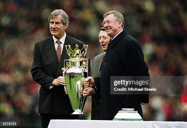 Manchester United chairman Martin Edwards and manager Alex Ferguson pose with the league title before the FA Barclaycard Premiership match against...