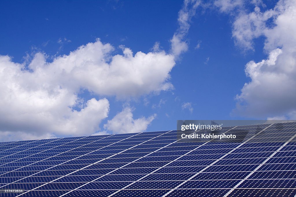 Solar panel with a blue cloudy sky