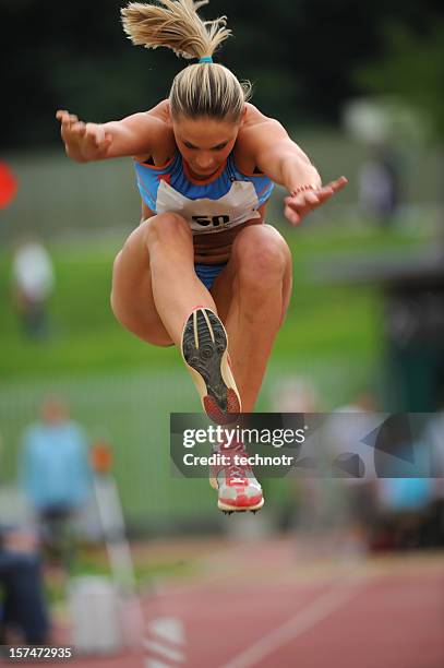 sportlerin im triple jump - woman long jump stock-fotos und bilder