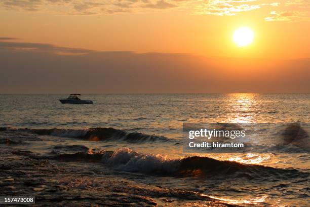 fishing boat, waves, morning on the shore of lake erie - lake erie stock pictures, royalty-free photos & images