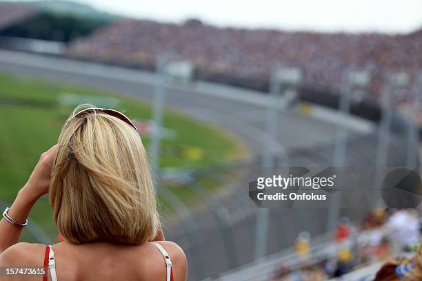 blond female fan from behind at an auto racing event - race spectator stock pictures, royalty-free photos & images