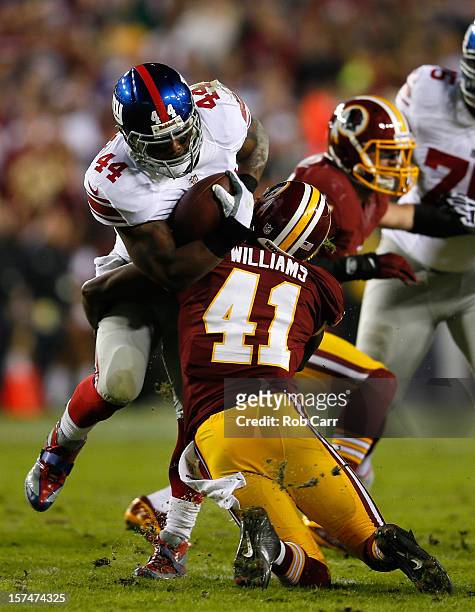 Running back Ahmad Bradshaw of the New York Giants runs the ball against Madieu Williams of the Washington Redskins in the first quarter at...