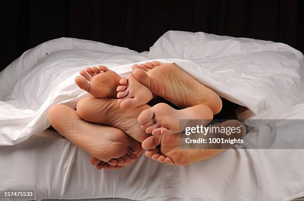 people having sex - woman lying on stomach with feet up stock pictures, royalty-free photos & images