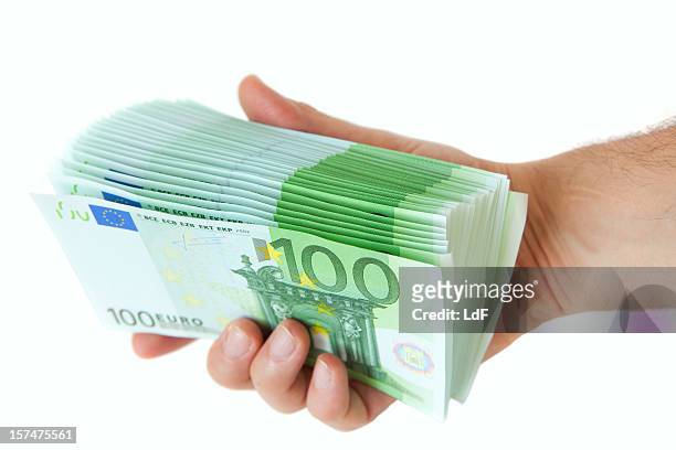 hand full of one hunders euro bills - one hundred euro note stock pictures, royalty-free photos & images