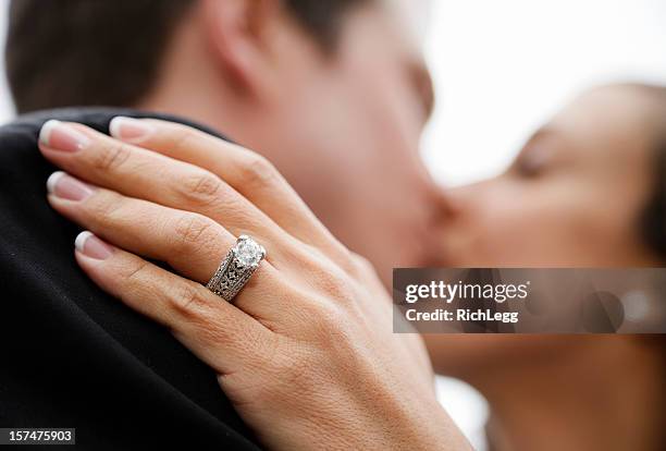 bride and groom kissing - man holding engagement ring stock pictures, royalty-free photos & images