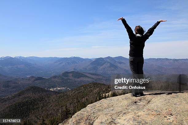 women hiker with arms raised on mountain summit - adirondack state park stock pictures, royalty-free photos & images