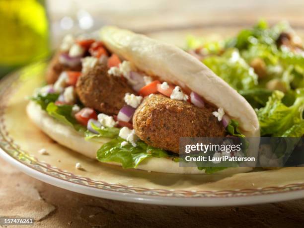 falafel wrap with ceaser salad - pita bread stock pictures, royalty-free photos & images