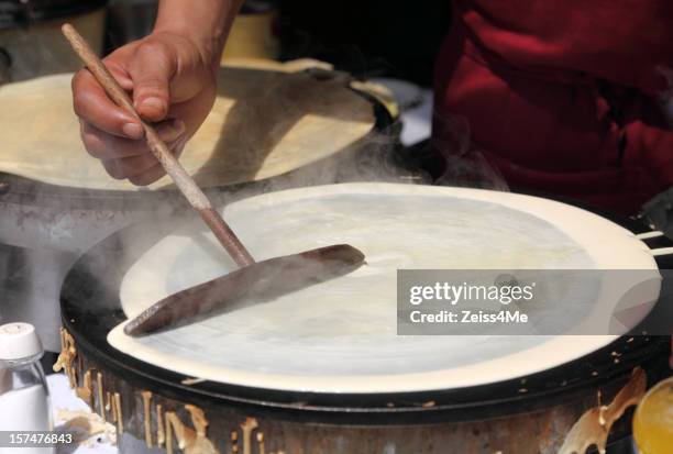 making crepes on a steaming hot griddle - crêpe pancake stock pictures, royalty-free photos & images