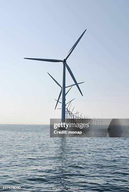 windturbine at the ocean outside copenhagen, vertical - windmill denmark stock pictures, royalty-free photos & images