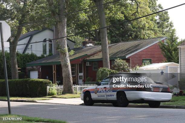 Massapequa Park, N.Y.: Nassau County police car is parked on First Avenue in Massapequa Park, outside the home of alleged killer of three sex workers...