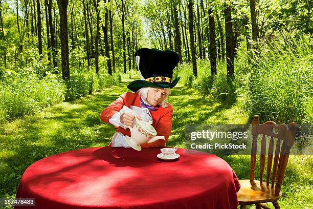 mad hatter has a spot of tea - mad hatter stock pictures, royalty-free photos & images