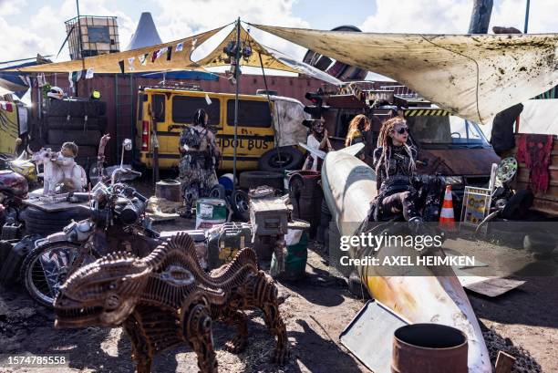 Residents of post-apocalyptic project 'Wasteland', a separate area on the Wacken Open Air's festival grounds, pose for photographers in Wacken,...