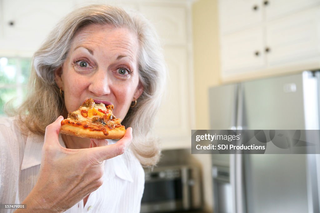 Senior Adult Woman Eating a Delicious Pizza