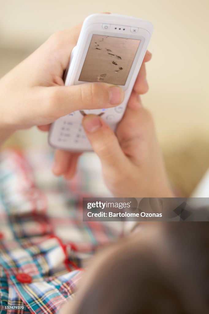 Little girl playing with mobile cel phone