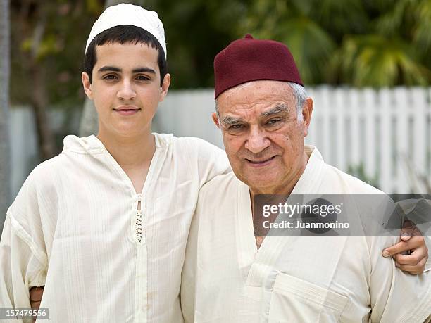 muslim grandfather and his grandson - egyptian family stock pictures, royalty-free photos & images