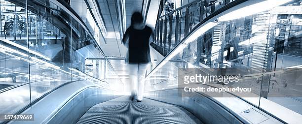 people on moving stairs in shopping center - entering shop stock pictures, royalty-free photos & images