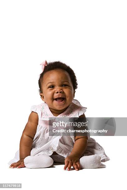smiling black baby wearing lacy pink gown sitting on floor - black baby 個照片及圖片檔
