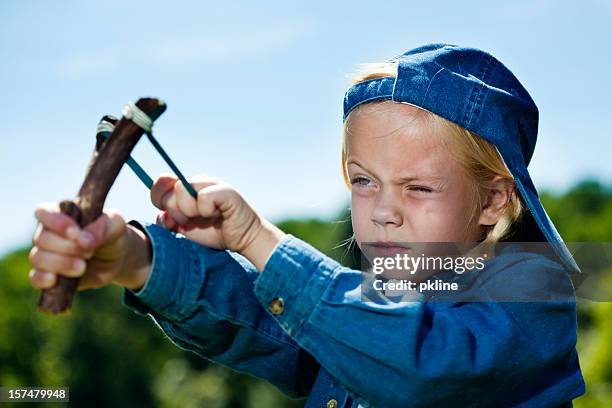 tomboy shooting slingshot - 6 year old blonde girl stock pictures, royalty-free photos & images