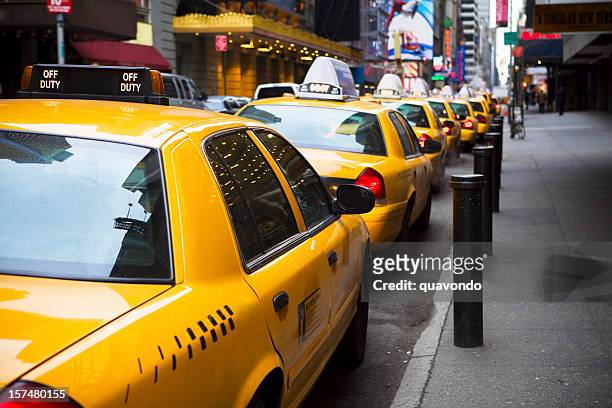 big line of yellow taxis in new york city - taxi stock pictures, royalty-free photos & images