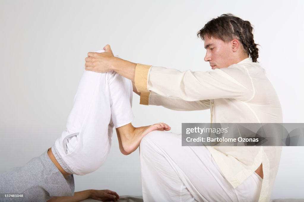 Zen Shiatsu therapist applying massage on a woman