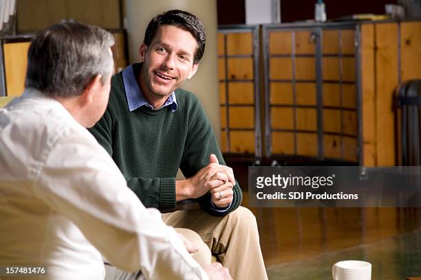 two friends having a good time talking together - preacher stock pictures, royalty-free photos & images