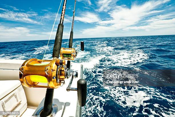 ocean fishing reels on a boat in the ocean - fishing rod bildbanksfoton och bilder