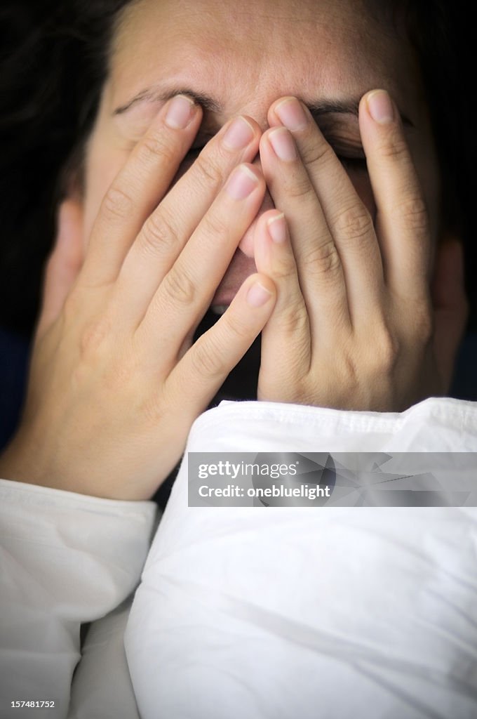 Woman with hands on her face