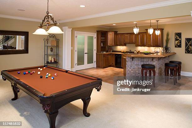 lower level game room and bar in residential home. - pool table stock pictures, royalty-free photos & images