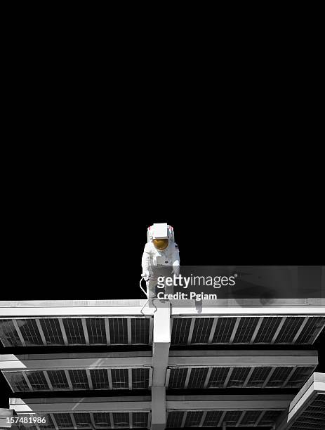 astronaut on a solar panel floating in space - astronaut space stock pictures, royalty-free photos & images