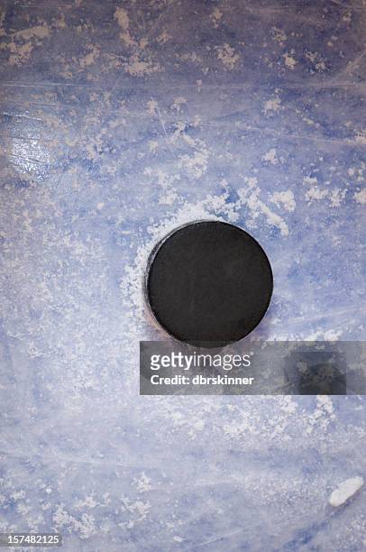 hockey puck on the blue line - hockey puck stock pictures, royalty-free photos & images