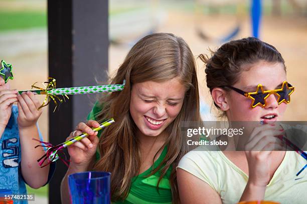 two girls at a teenage girl's birthday party - birthday girl stock pictures, royalty-free photos & images