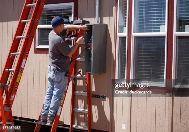 electrician working on electrical service panel - electrical panel box stock pictures, royalty-free photos & images