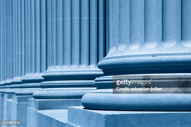 diagonal view of large blue columns - new york state government stock pictures, royalty-free photos & images