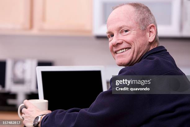 active senior citizen using laptop in kitchen, copy space - computer screen over shoulder stock pictures, royalty-free photos & images