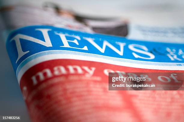 folded financial newspaper on table, close-up - western script stock pictures, royalty-free photos & images