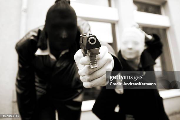 armed bank robbers - bank robber stock pictures, royalty-free photos & images